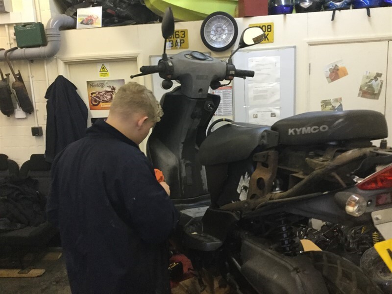 Alfie removing his bike's body plastics for repairing and spraying